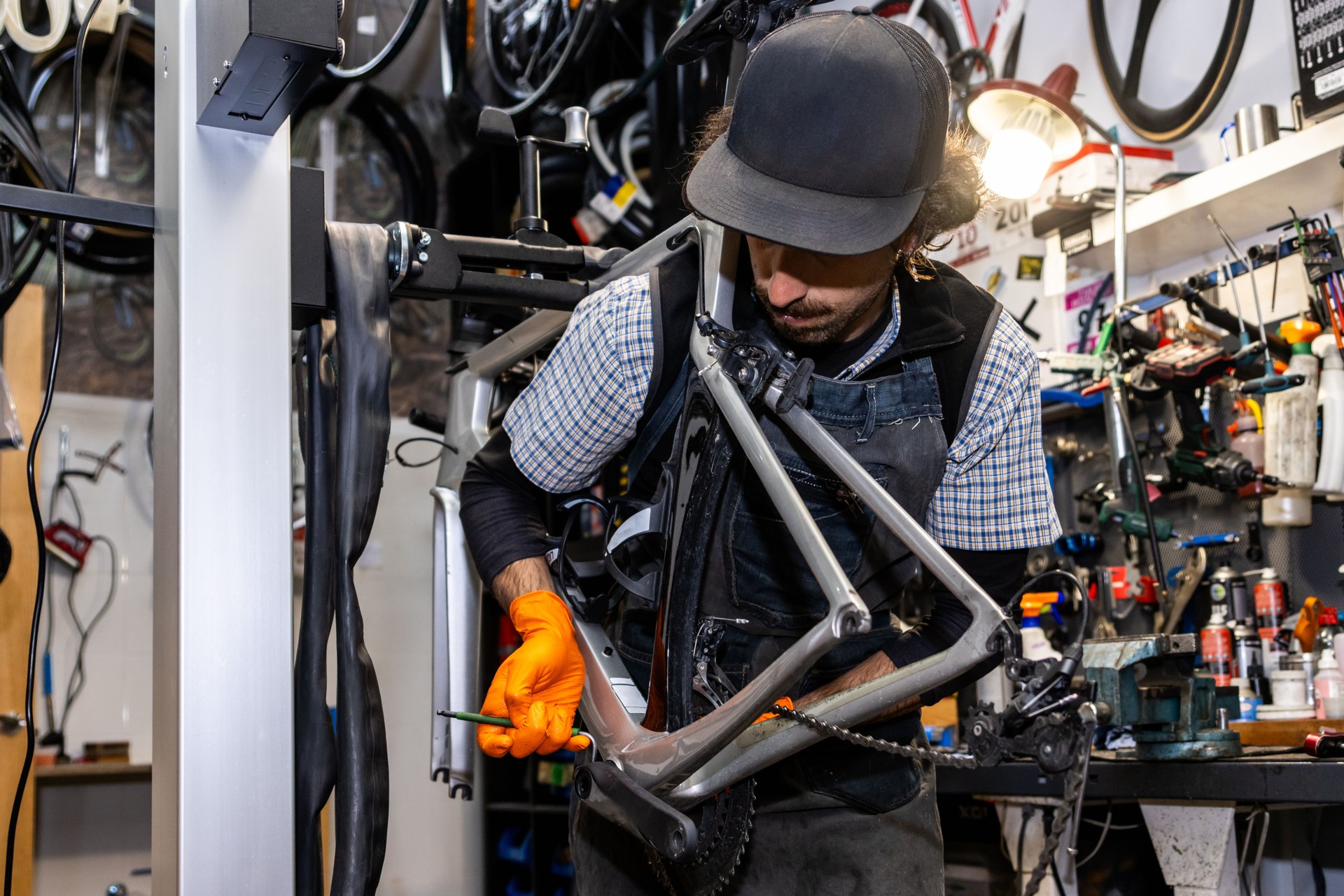 Bicycle mechanic working on bike frame in repair shop